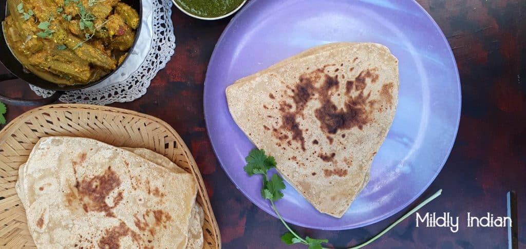 Indian dinner with triangle paratha and curries